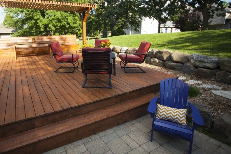 Above ground timber decking floor. The plastfor has no roof and there are some outdoor chairs