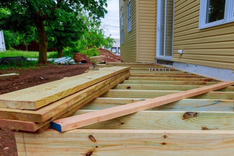 woods layed out in the ground for house timber decking