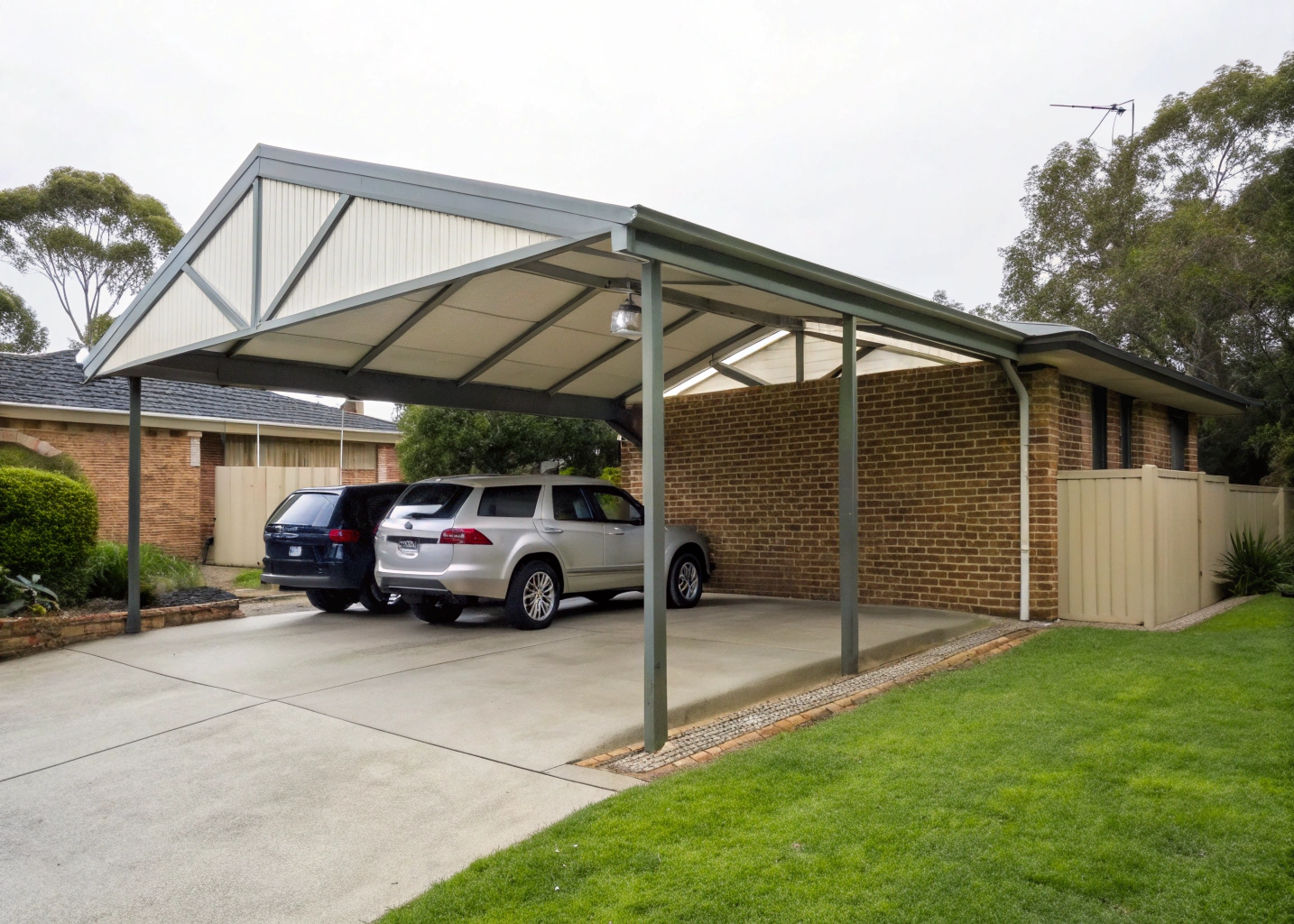 Double Colorbond gable carport attached to a brick veneer home in Newcastle